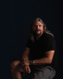 Moody studio portrait of a man with long hair