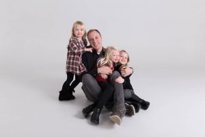 Dad and his daughters, Christmas portrait in studio