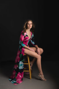 Glamour photography of a young woman sitting on a stool