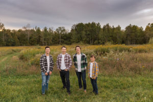 Portrait of four sons with a moody sky