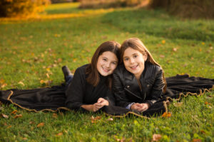 Sisters fall portrait at golden hour